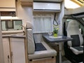 Dining table, rear seats and part of kitchen tablein modern italian campervan Giottiline Royalty Free Stock Photo