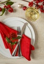 Christmas dinner table place setting with festive seasonal decorations