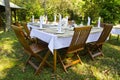 Dining table set in lush garden