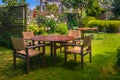 Dining Table set in Lush Garden Royalty Free Stock Photo