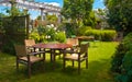 Dining Table set in Lush Landscaped Garden Royalty Free Stock Photo