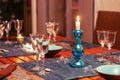 Dining table setting with glasses, decorations and candles