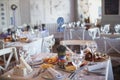 Dining table setting at Provence style, with candles, lavender, vintage crockery and cutlery, closeup. Royalty Free Stock Photo