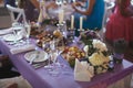 Dining table setting at Provence style, with candles, lavender, vintage crockery and cutlery, closeup. Royalty Free Stock Photo