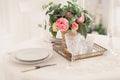 Dining table setting at Provence style, with candles, lavender, vintage crockery and cutlery, closeup. Royalty Free Stock Photo