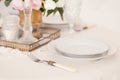 Dining table setting at Provence style, with candles, lavender, vintage crockery and cutlery, closeup. Royalty Free Stock Photo