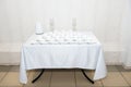 Dining table setting at Provence style, with candles, lavender, vintage crockery and cutlery, closeup.