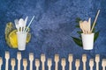 Dining utensils: spoon, fork, knife, plastic bag, plastic cup, straws. Wooden against plastic, ecological vs. non-ecological on