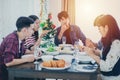 Dinner with Asian Group of best friends enjoying evening drinks while sitting at the dinning table on the kitchen together Royalty Free Stock Photo