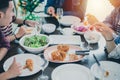 Dinner with Asian Group of best friends enjoying evening drinks while sitting at the dinning table on the kitchen together Royalty Free Stock Photo