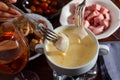 Dinner with cheese fondue, sausages and bread