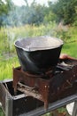 Dinner cooking on an open fire in the garden Royalty Free Stock Photo