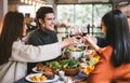 Dinner with friends. Group of young people enjoying dinner together. Dining Wine Cheers Party thanksgiving Concept. Royalty Free Stock Photo