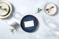 Dinner invitation mockup with modern ceramic tableware and olive branches Royalty Free Stock Photo