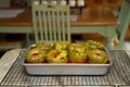 Stuffed Green Peppers in Tomato Sauce Cooling on Baker`s Rack on Kitchen`s Countertop. Royalty Free Stock Photo