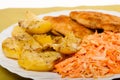 Dinner meal. Fried chicken roasted potatos and carrot salad. Royalty Free Stock Photo