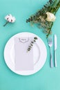 Dinner menu for a wedding or luxury evening meal. Table setting from above. Elegant empty plate, cutlery and flowers. Royalty Free Stock Photo