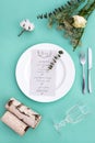 Dinner menu for a wedding or luxury evening meal. Table setting from above. Elegant empty plate, cutlery, glass and flowers Royalty Free Stock Photo