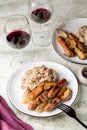 Dinner. Oven baked turkey sausages with apples and shallot onions with mashed potatoes and beans. Royalty Free Stock Photo