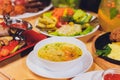 Dinner party food concept. Dinner table with grilled sausage, tortilla wraps, beer drink and different dishes on wooden Royalty Free Stock Photo