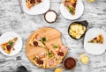 Dinner with pieces of pizza on board and plates Royalty Free Stock Photo