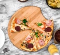 Dinner with pieces of pizza on board and plates Royalty Free Stock Photo