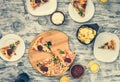 Dinner with pieces of pizza on board and plates Royalty Free Stock Photo