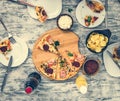 Dinner with pieces of pizza on board and plates Royalty Free Stock Photo