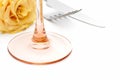 Dinner place setting. Knife and fork and glass with yellow rose Royalty Free Stock Photo