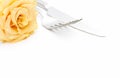 Dinner place setting. Knife and fork with yellow rose Royalty Free Stock Photo