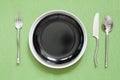 dinner place setting a white plate with silver fork and spoon gr Royalty Free Stock Photo