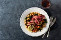 Dinner plate with beef steak with white beans, spinach, tomatoes and glass of red wine top view with copy Royalty Free Stock Photo