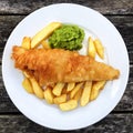 A dinner plate of fish and chips with mushy peas Royalty Free Stock Photo