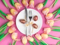 dinner plate with gold easter eggs, bow, tulips Royalty Free Stock Photo