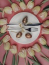 dinner plate with gold easter eggs, bow, tulips Royalty Free Stock Photo
