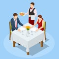 Dinner In Restaurant. Young couple having dinner in a restaurant. Man and woman sitting at the table, the waiter takes Royalty Free Stock Photo