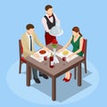 Dinner In Restaurant. Young couple having dinner in a restaurant. Man and woman sitting at the table, the waiter takes