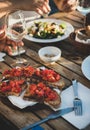 Dinner with salad, bruschetta with tomato and white wine