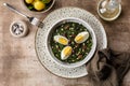 Dinner with Sauteed Agretti with Taggiasca olives, pinoli or pine nut, and boiled eggs. Royalty Free Stock Photo