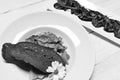 Dinner served on traditional plate with meat and vegetables on square plate. Main meal with bread on white wood Royalty Free Stock Photo