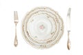 Dinner set with three plates, knife and fork isola