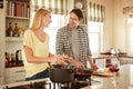Dinner, speaking or happy couple kitchen cooking with healthy food or vegetables for lunch together at home. Support or Royalty Free Stock Photo