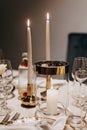 Dinner table adorned with lit candles and elegant glassware Royalty Free Stock Photo