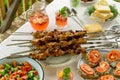 Dinner table with barbecue, snacks and strawberry lemonade Royalty Free Stock Photo