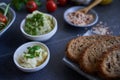 Dinner table with bread, cheese, vegetables and different types of meals Royalty Free Stock Photo