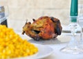 Dinner table with a chicken and corn