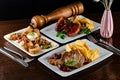 Dinner table with different dishes, three-course set on the table. Different food on a wooden table. Three course menu