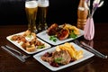 Dinner table with different dishes, three-course set on the table. Different food on a wooden table. Three course menu