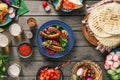 Dinner table with grilled sausage, tortilla, beer and different Royalty Free Stock Photo