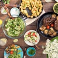 Dinner table with grilled steak, vegetables, potatoes, salad, sn Royalty Free Stock Photo